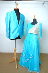 Couple outfit set featuring aqua blue men’s blazer and silver-accented aqua gown with layered detailing