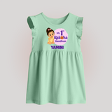 My First Raksha Bandhan Baby Girl Baby Frock – girl sitting with Rakhi theme. - MINT GREEN - 0 - 3 Months Old (Chest 17")