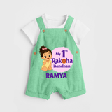 My First Raksha Bandhan Baby Girl Dungaree – girl sitting with Rakhi theme. - GREEN - 0 - 5 Months Old (Chest 18")
