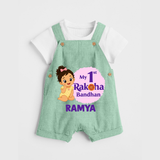 My First Raksha Bandhan Baby Girl Dungaree – girl sitting with Rakhi theme. - MINT GREEN - 0 - 5 Months Old (Chest 18")