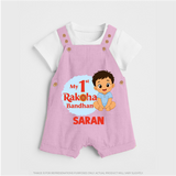 My First Raksha Bandhan Baby Boy Dungaree– boy sitting with Rakhi theme. - BABY PINK - 0 - 5 Months Old (Chest 18")