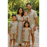 Indian family wearing coordinated beige cheetah print outfits – mom, dad, baby, son, and daughter in neutral-toned matching cotton clothing set