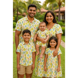 Indian family in coordinated yellow tropical fruit print cotton outfits – mom, dad, son, daughter, and baby in bright summer-themed matching clothing