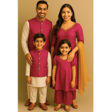Family wearing coordinated magenta and cream raw silk ethnic outfits — father, mother, son, and daughter in matching traditional Indian attire.