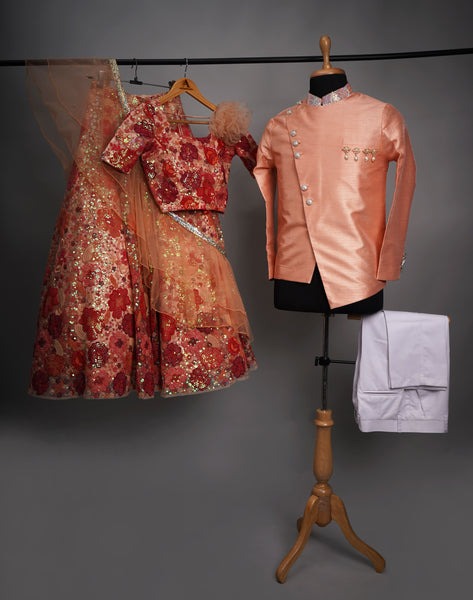 Kids ethnic sibling combo with coral lehenga choli and peach indo-western jacket set