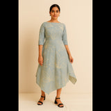 Woman wearing sea green asymmetric dress with floral print and 3/4 sleeves
