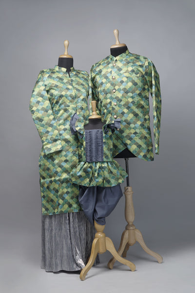 Emerald & Silver Family Ethnic Wear Set with scallop pattern – mom tunic and pleated skirt, dad asymmetric kurta, baby girl peplum top with dhoti.
