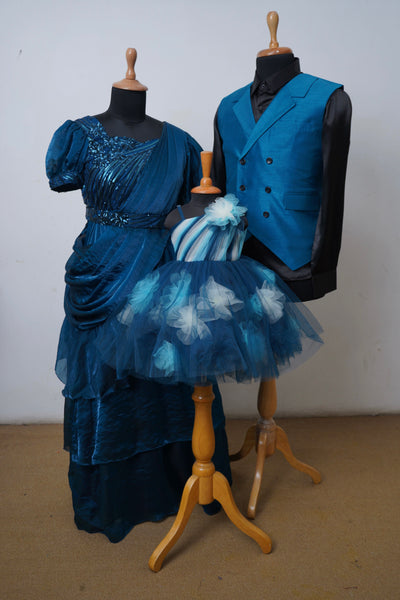 Family matching outfit in midnight blue with sequin gown for mom, waistcoat and shirt for dad, and floral tulle frock for daughter