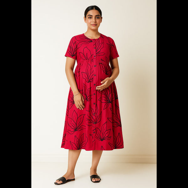 Pregnant woman wearing red maternity dress with black leaf print, front button closure and short sleeves