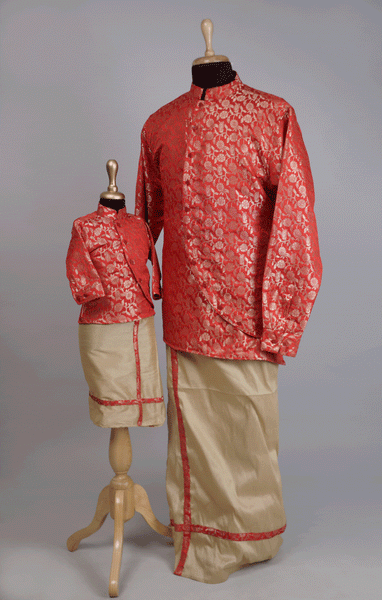 Father and son wearing matching red brocade kurta and beige veshti traditional outfit set.