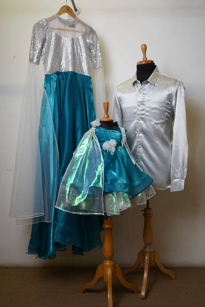 Coordinated Frozen-themed family outfit with silver and teal color, featuring a sequin gown, satin shirt, and a princess dress.