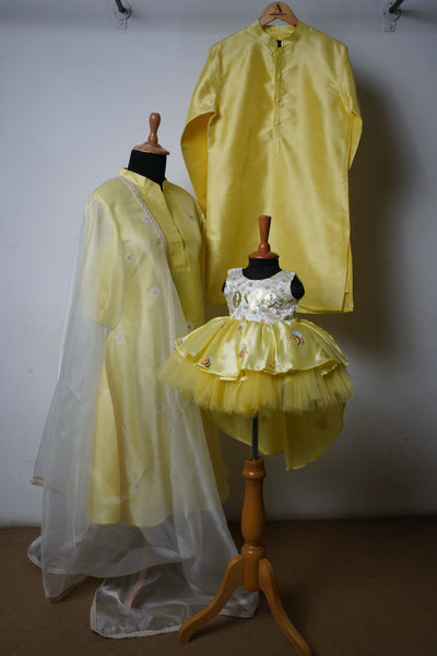 Sunshine yellow family ethnic wear set including kurta for dad, anarkali for mom, and bee-themed frock for baby girl