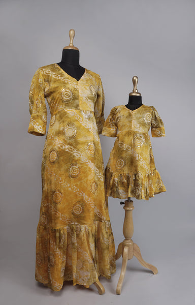 Radiant Yellow Bandhani Matching Dress Set for Mother and Daughter with traditional prints and sequin details.
