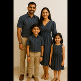 Family outfit set with teal and floral theme – includes a women’s dress, men’s shirt, and matching boy’s shirt displayed on mannequins.