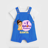My First Raksha Bandhan Baby Girl Dungaree – girl sitting with Rakhi theme. - COBALT BLUE - 0 - 5 Months Old (Chest 18")