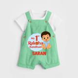 My First Raksha Bandhan Baby Boy Dungaree– boy sitting with Rakhi theme. - GREEN - 0 - 5 Months Old (Chest 18")