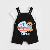 My First Raksha Bandhan Baby Boy Dungaree– boy sitting with Rakhi theme. - BLACK - 0 - 5 Months Old (Chest 18")