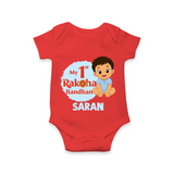 My First Raksha Bandhan Baby Boy Romper – boy sitting with Rakhi theme. - RED - New Born (Chest 14")