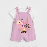 My First Rakhi Baby Boy Cute Graphic Dungaree – baby with “my first rakhi” illustration. - BABY PINK - 0 - 5 Months Old (Chest 18")