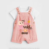My First Rakhi Baby Boy Cute Graphic Dungaree – baby with “my first rakhi” illustration. - PEACH - 0 - 5 Months Old (Chest 18")