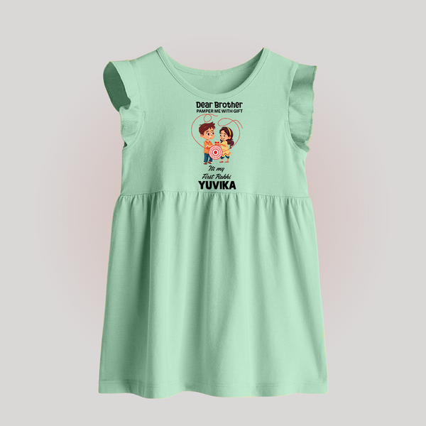 First Rakhi CelebrationBrother Sister Print Baby Frock – simple baby holding rakhi illustration. - MINT GREEN - 0 - 3 Months Old (Chest 17")
