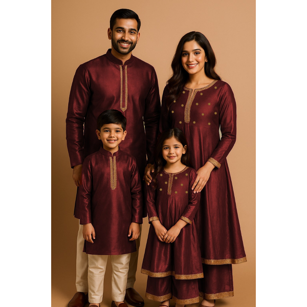 Indian family wearing coordinated raw silk ethnic outfits with golden lace detailing — dad in kurta, mom in Anarkali set, son in kurta, and daughter in frock with palazzo — festive family ethnic wear set.