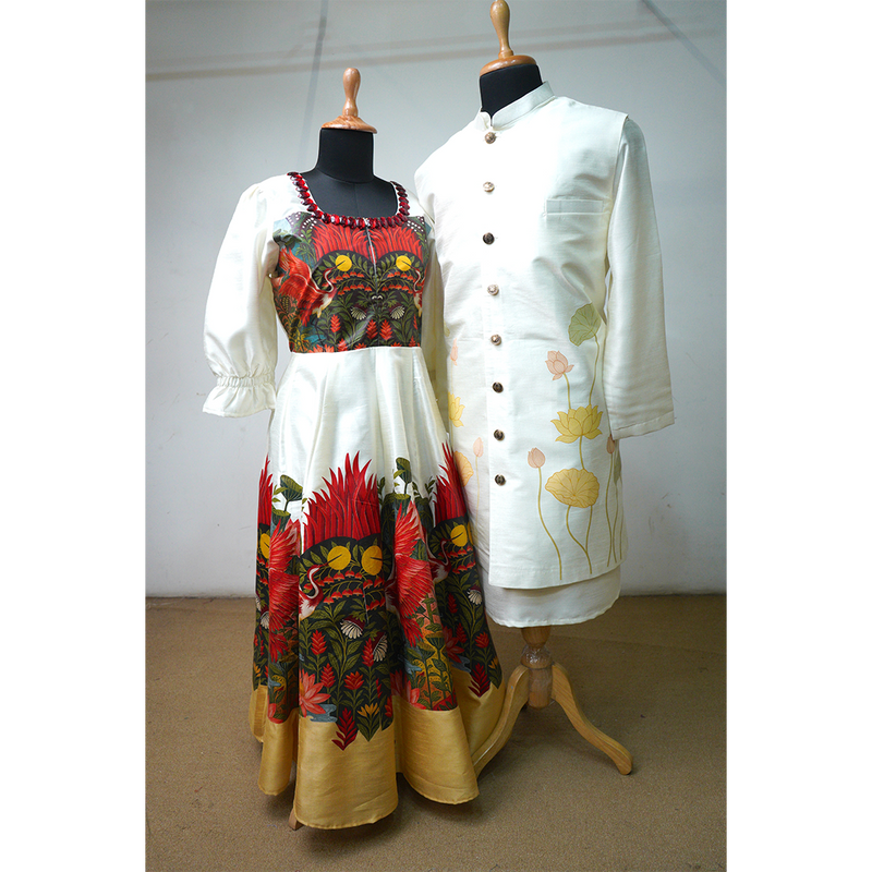 Ivory floral couple outfit set featuring printed silk gown with puff sleeves and mandarin-collared men's kurta with lotus motifs