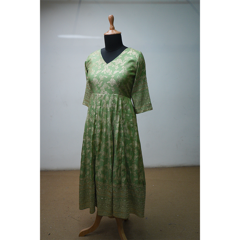 Green brocade ethnic dress with golden floral motifs and elbow-length sleeves