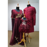 Burgundy family outfit set featuring embroidered gown for mom, kurta for dad, and glittery star frock for baby girl