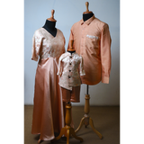 Family matching peach shimmer outfits – brocade gown for mom, satin shirt for dad, brocade kurta set for boy
