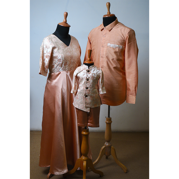Family matching peach shimmer outfits – brocade gown for mom, satin shirt for dad, brocade kurta set for boy