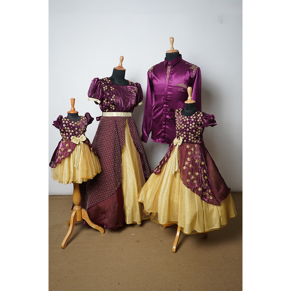 Coordinated family outfit set in plum and gold featuring embroidered dresses for mom and daughters, and a satin shirt for dad.