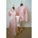 Family matching satin outfit set in pastel blush pink for dad, mom, and son.