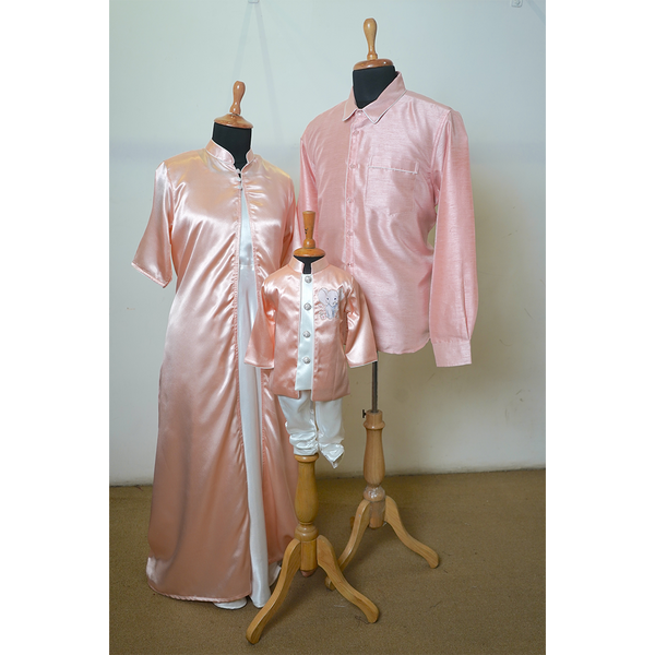 Family matching satin outfit set in pastel blush pink for dad, mom, and son.