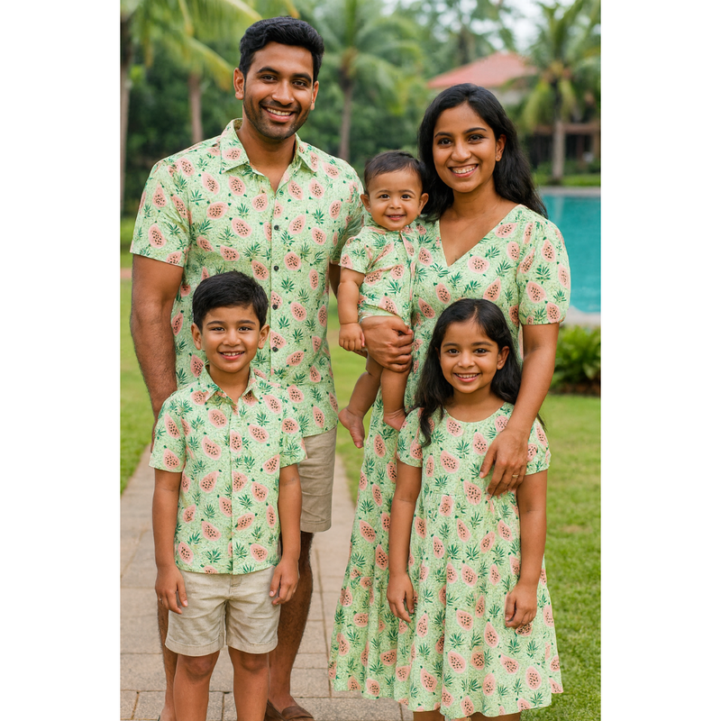 Indian family in coordinated light green pineapple print cotton outfits – mom, dad, son, daughter, and baby in tropical-themed matching clothing