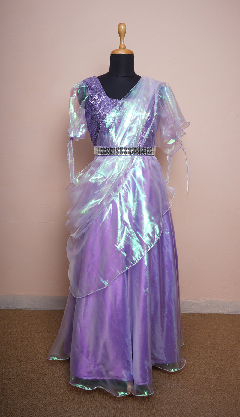 glass organza dress A teal-blue glass tissue organza gown, cut with sculptural off-shoulder draping and fluid, light-catching pleats. Weightless yet commanding, it glows against the city at dusk a study in modern elegance and