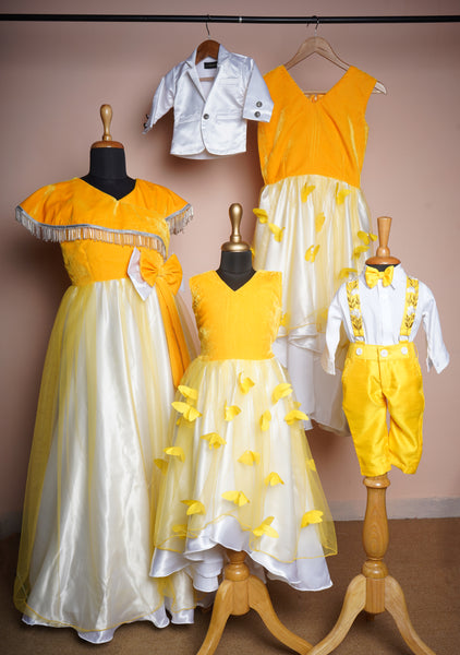 Butter yellow and white family matching outfit set with a tassel-trim gown, butterfly dresses for girls, and bow tie suspenders for boys.