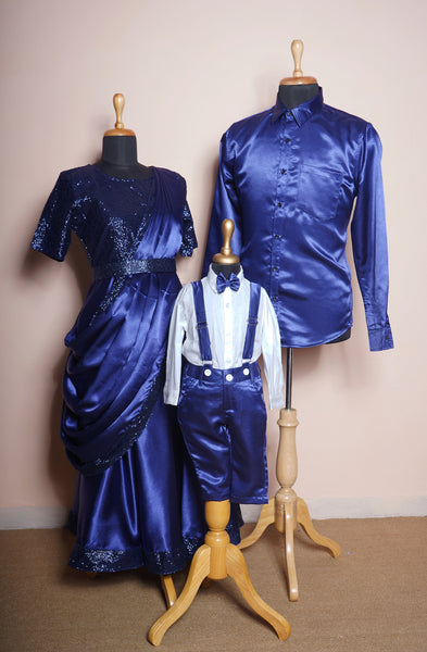 Royal blue satin family matching outfit set with sequin saree gown for mom, satin shirt for dad, and suspender pants set for boys.